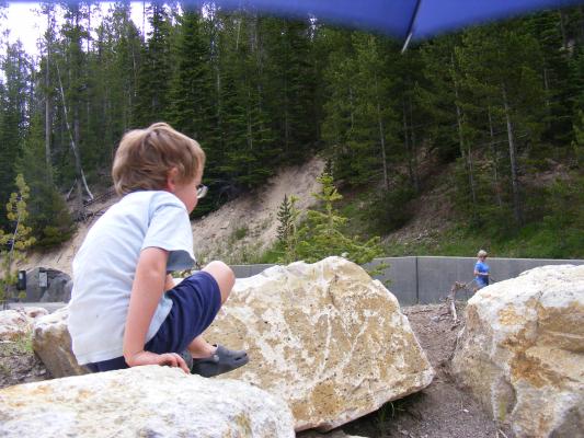 Noah climbs rocks.