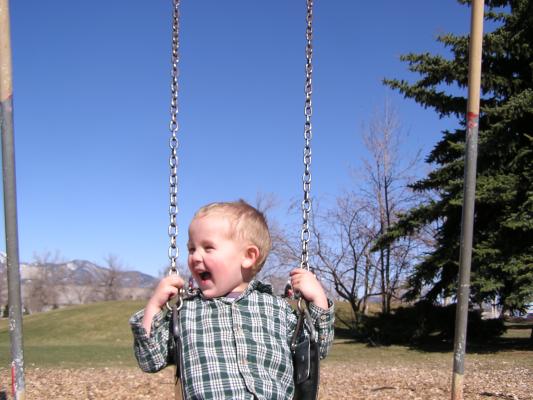 Noah swings at the park.