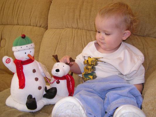 Noah plays with his singing snow man.