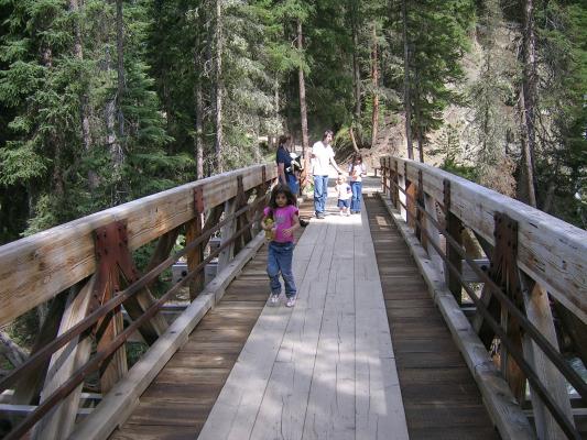 The expedition traverses the raging perils of the South Fork of the West Fork of the Gallatin River below.