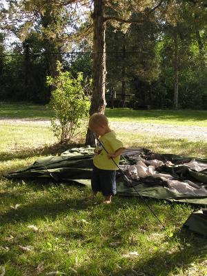 Noah figures out the tent poles.
