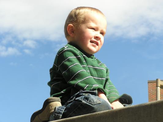 Noah climbs the wall.
