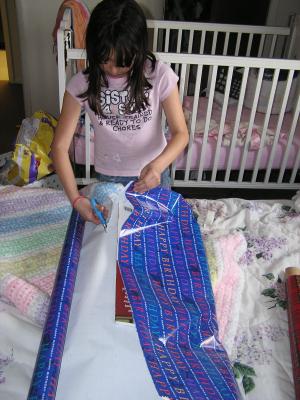 Malia wraps the gift.