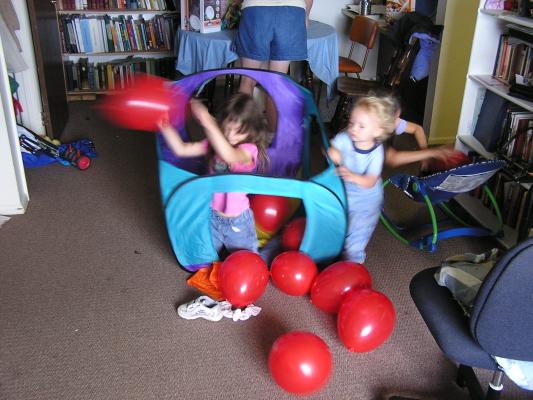 Noah and Andrea play with balloons.