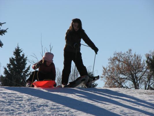 Andrea and Malia sledding.