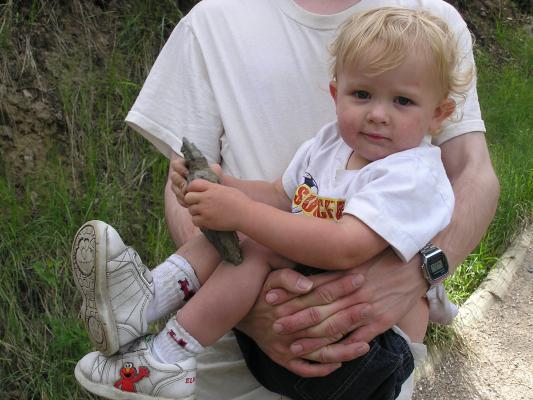 David carries Noah and a rock.