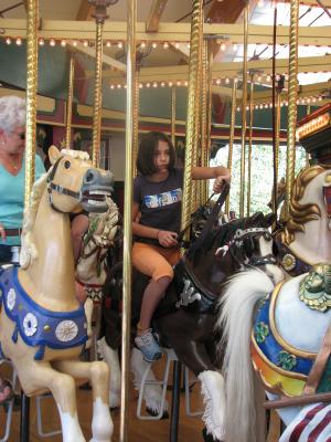 Malia rides the carousel