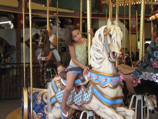 Andrea on a hand carved carousel horse in Missoula