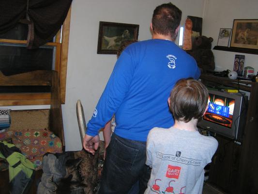 Titus plays a Star Wars game with a light saber.