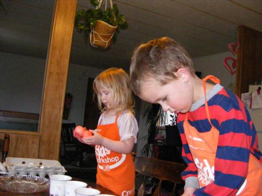 Sarah and Noah in orange aprons