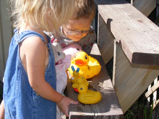 Noah and Sarah play with ducks