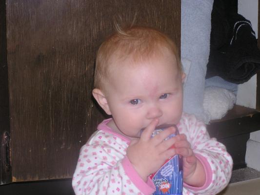 Sarah tastes the toothpaste container.