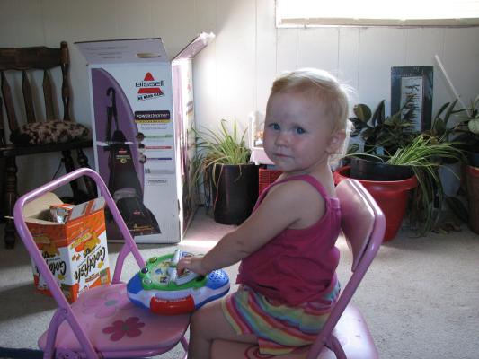 Sarah plays with the ABC toy
on the pink chairs