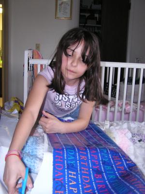 Malia wraps the gift.