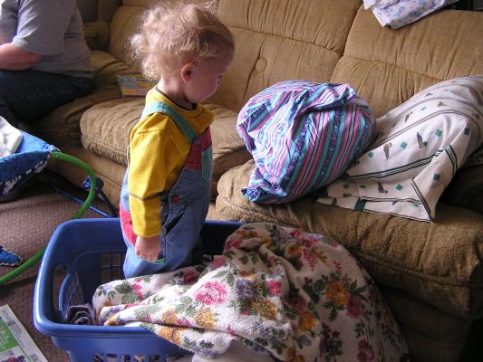 Noah considers whether to fold the pillows too.