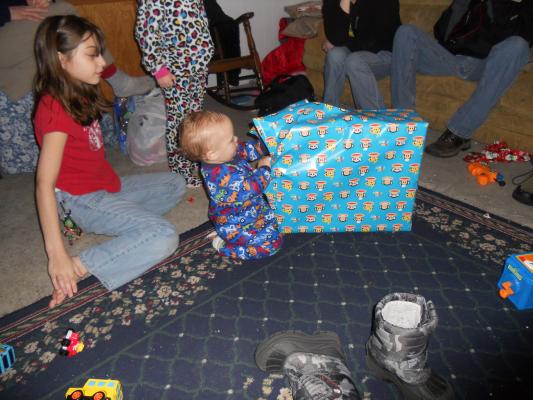 Joshua opens a birthday gift. 