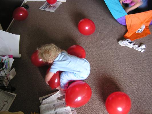 Noah plays with balloons.