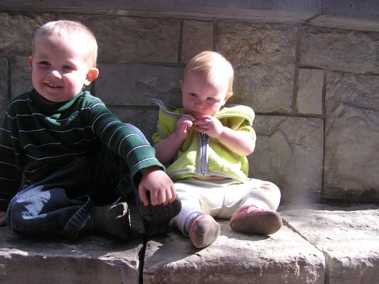 Noah and Sarah by a rock wall at MSU.