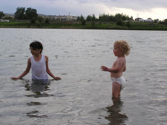 Malia and Noah play in the lake.