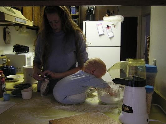 Noah helps mix the dough.