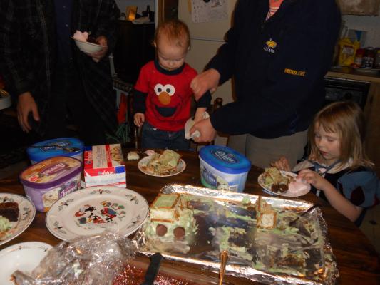 The happy cake table. Joshua is getting cleaned up.