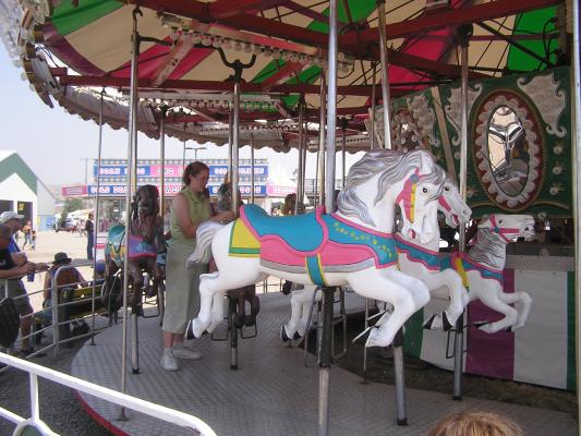Katie helps Sarah take a ride.