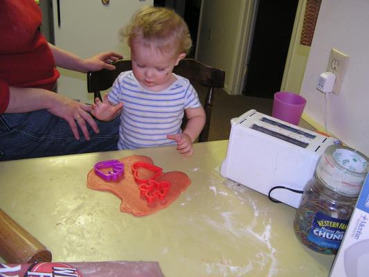 Noah cuts out sugar cookies for Valentines Day.