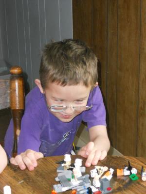 Noah builds with Legos. 