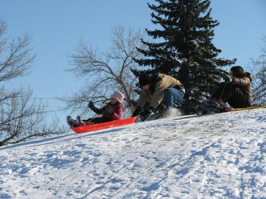 Andrea and Malia sledding.
