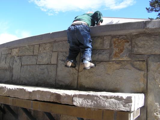 Noah climbs the wall.