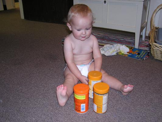 Noah plays with the fish food.