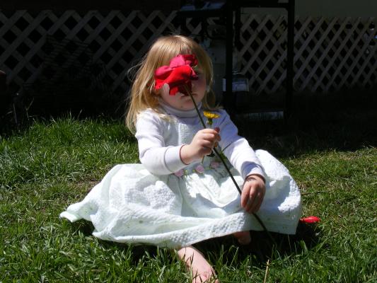 Sarah with a rose in front of her face.