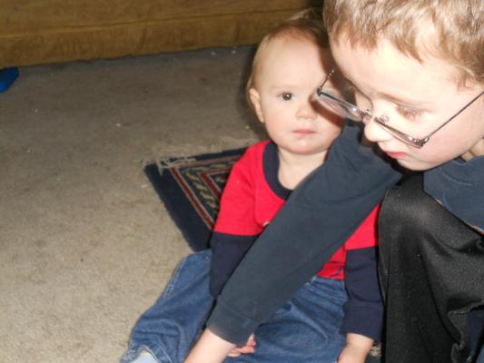 Noah helping Joshua on his birthday. 