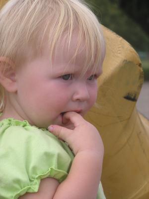 Sarah by a tire at the park.