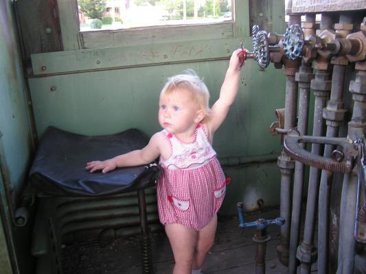 Sarah plays on an old train