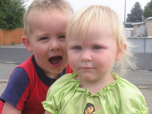 Noah and Sarah on a tire at the park.