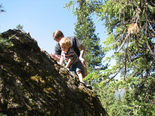 DAvid and Noah climb a rock