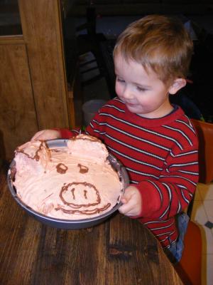 Noah is proud of the pig cake