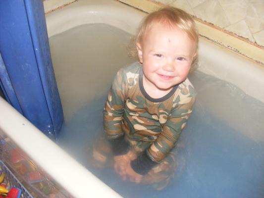 Joshua got back into the bath after he had is jammies on. 