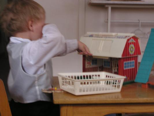 Noah plays with the barn