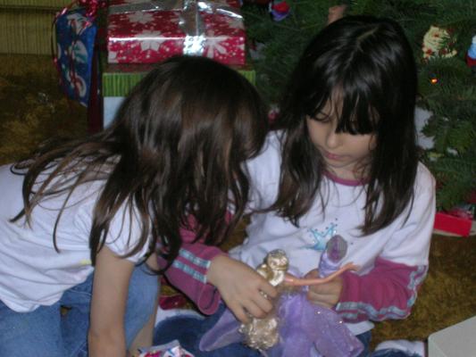 Andrea and Malia look at their action figures.