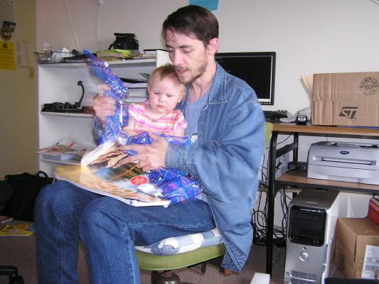 Sarah and David unwrap the birthday gift.