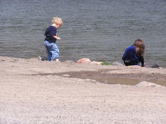 Noah and Andrea throw rocks at Hyalite Reservoir.