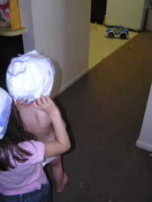 Andrea helps Noah put a diaper on his head.