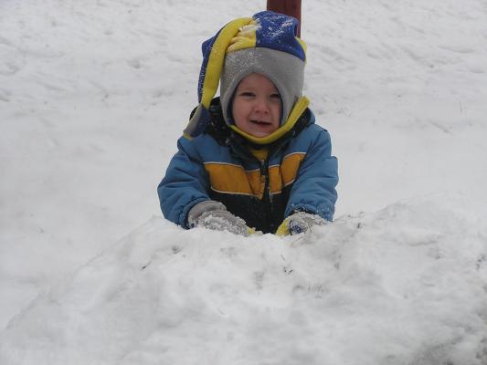 Noah plays on the snow fort.