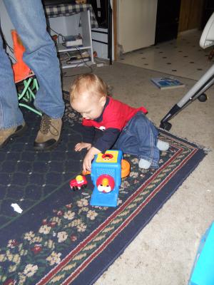 Joshua has a little car from Grandma and Grandpa Eder and Elmo-in-the-box. 