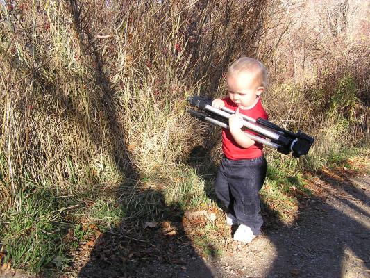 Noah is a good helper. He decided to carry the tripod.