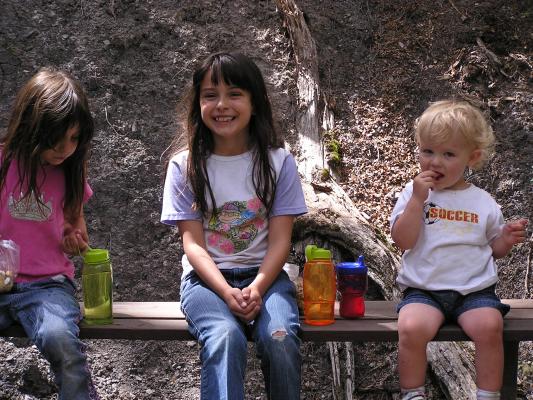 Andrea, Malia and Noah take a break on a bench.
Noah eats some candy.
