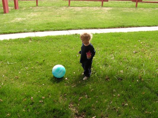 Noah plays with his blue ball.