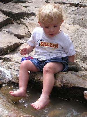 Noah plays in the puddles on top of Ousel Falls.